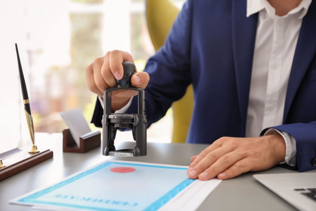 man uses a stamper for approval