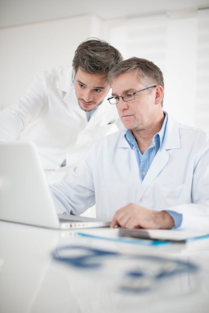 A Doctor teaching his understudy about CPT medical coding.