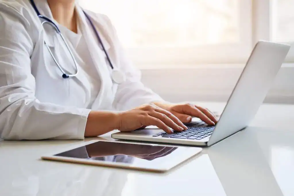 healthcare professional works on their LegitScript certification on their computer